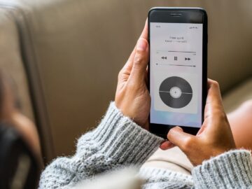 Woman lying down listening to streamed music from her phone