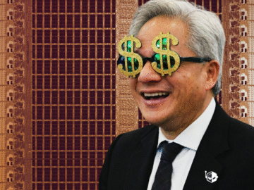 A man wearing dollar sign glasses in front of a semiconductor wafer background.