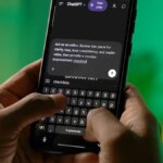 shot of hands typing the best AI prompts on a phone